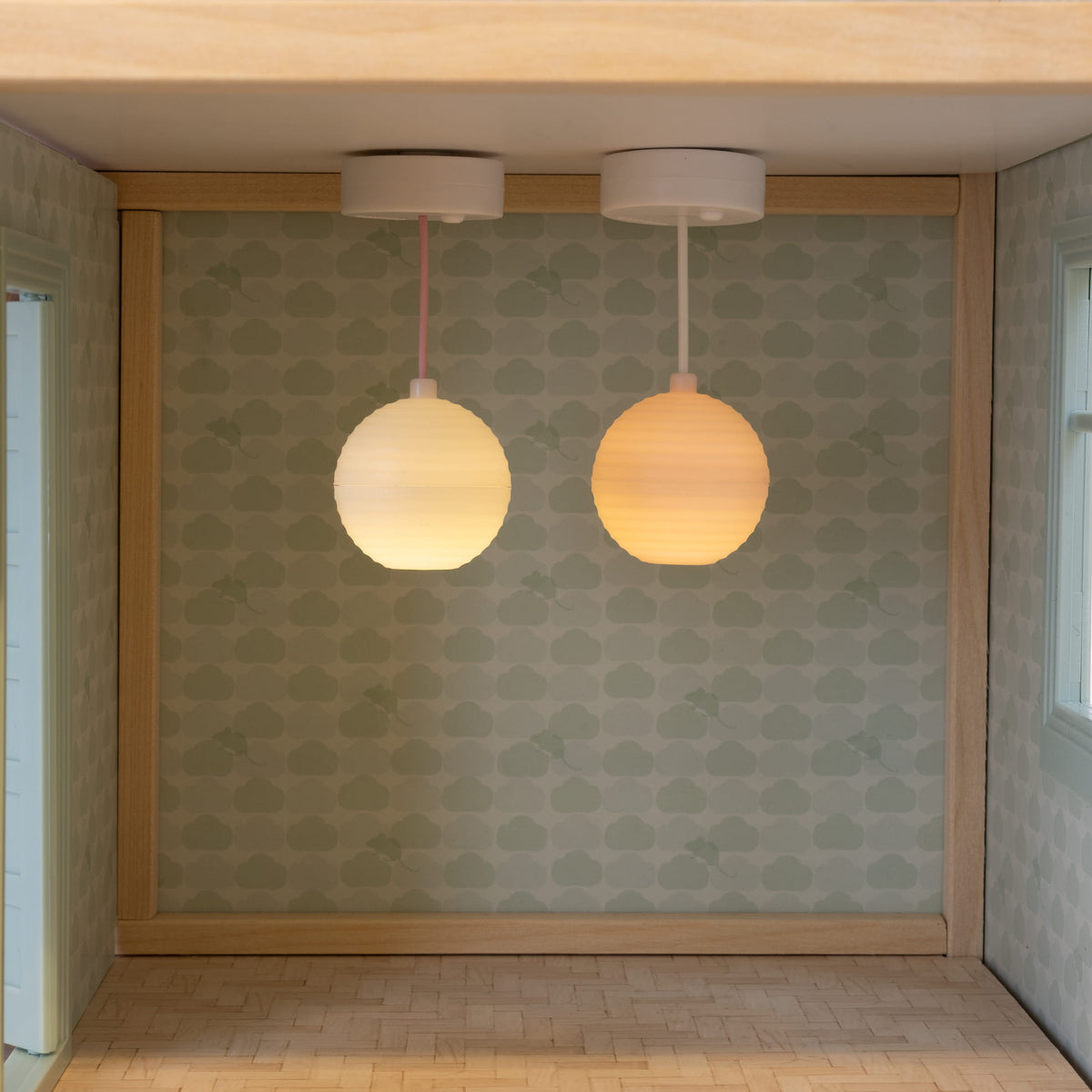 Lundby battery-powered LED dolls house lamps switched on, lighting an empty dolls house room.